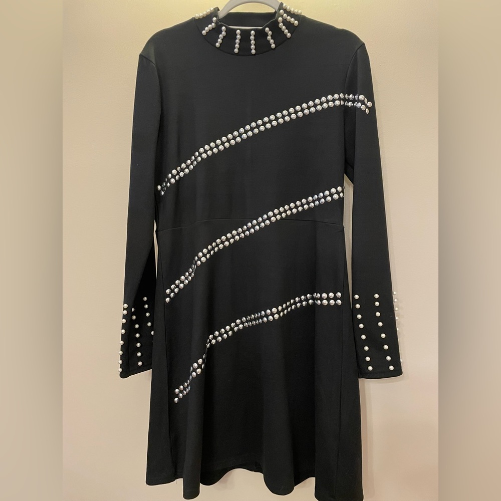 A classic black dress with pearls designs.